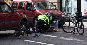 Cyclist and driver checking man injured in bike accident