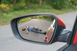 Pedestrian hit by car reflected in mirror