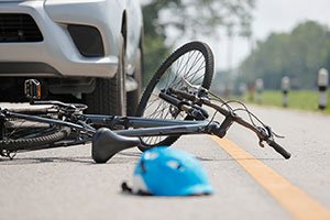 Bike laying on the road after being hit by a car.