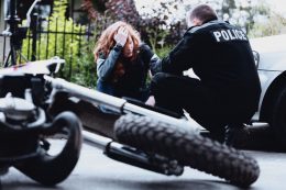 Police interviewing woman after a motorcycle accident